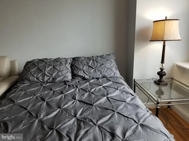 a bed sitting in a bedroom next to a lamp