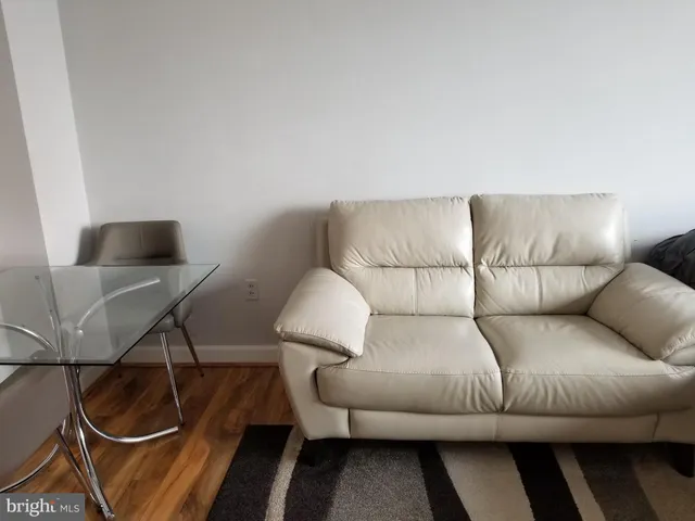 a living room with furniture and a lamp