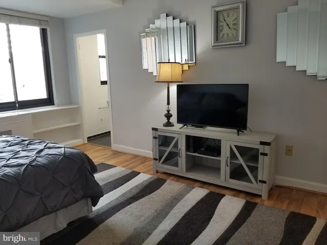 a bedroom with a bed and a flat screen tv