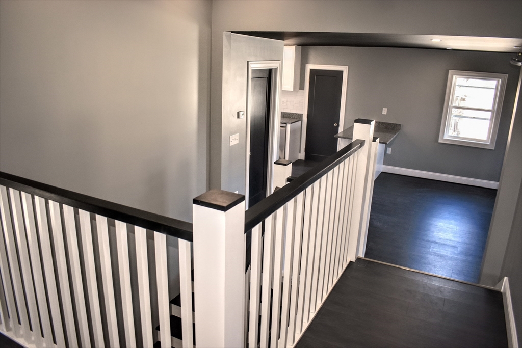 2 Sunnyside Street, Unit 2 Boston, MA 02130 - Photo 11 of 41 a view of a hallway with wooden floor and stairs