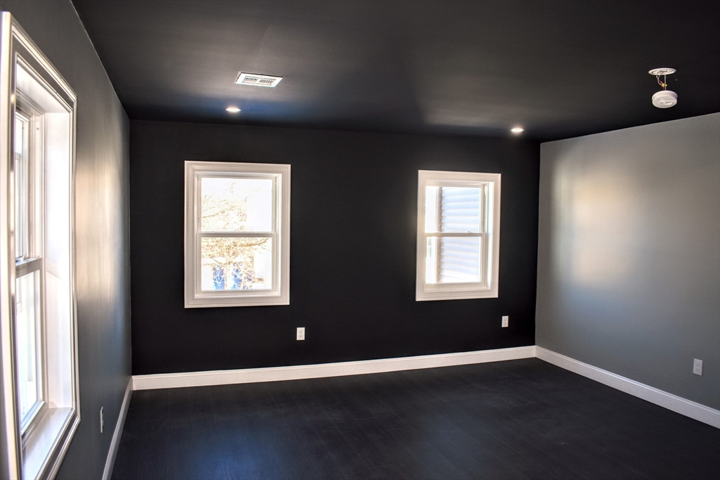 2 Sunnyside Street, Unit 2 Boston, MA 02130 - Photo 13 of 41 a view of an empty room with wooden floor and a window