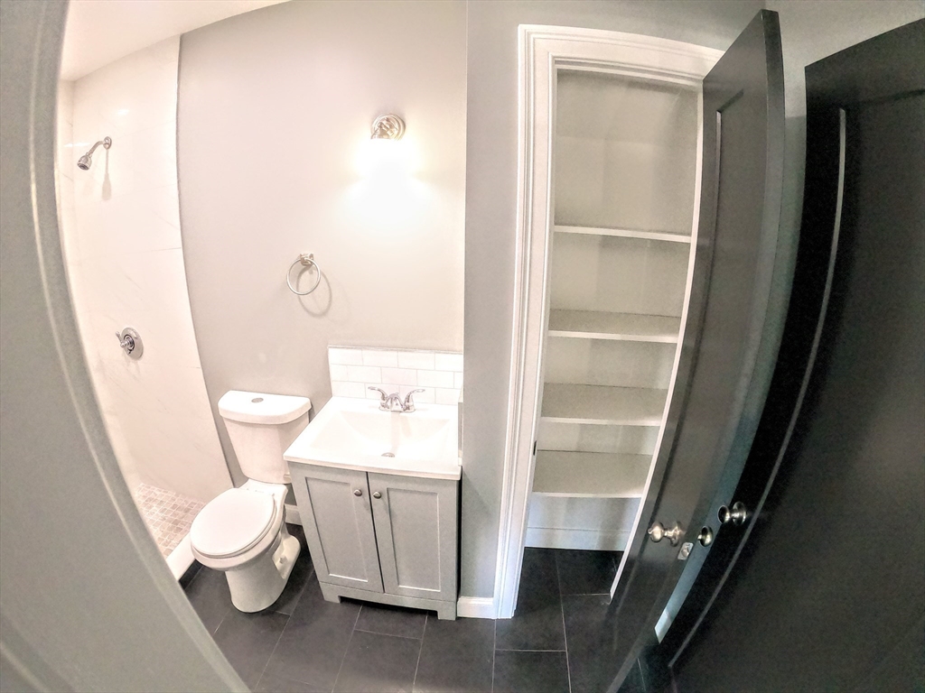 2 Sunnyside Street, Unit 2 Boston, MA 02130 - Photo 24 of 41 a white toilet sitting next to a bathroom sink