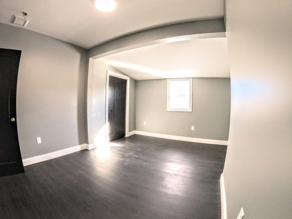 2 Sunnyside Street, Unit 2 Boston, MA 02130 - Photo 27 of 41 an empty room with wooden floor and windows