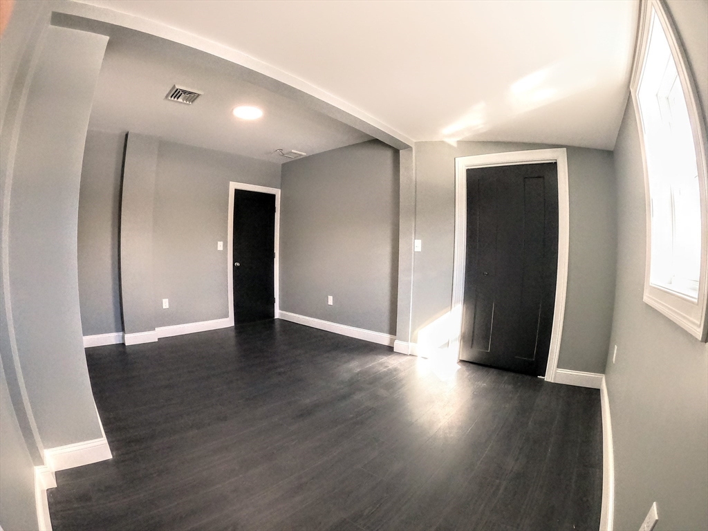 2 Sunnyside Street, Unit 2 Boston, MA 02130 - Photo 28 of 41 a view of a livingroom with wooden floor and window