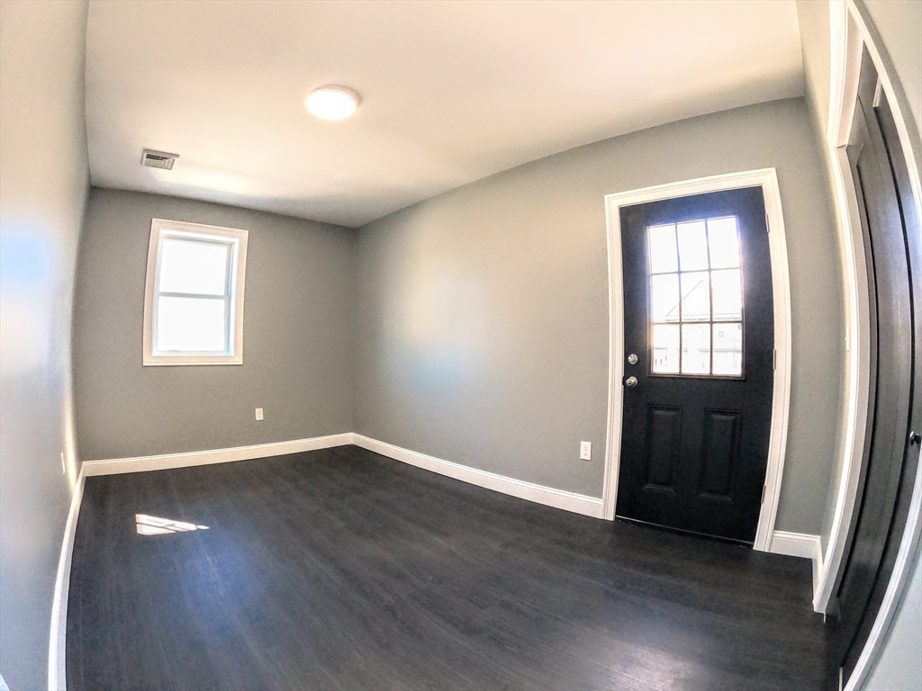 2 Sunnyside Street, Unit 2 Boston, MA 02130 - Photo 29 of 41 an empty room with wooden floor and windows