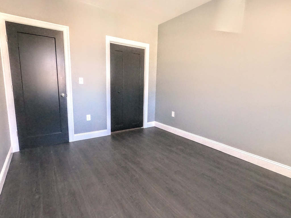2 Sunnyside Street, Unit 2 Boston, MA 02130 - Photo 36 of 41 an empty room with wooden floor and closet