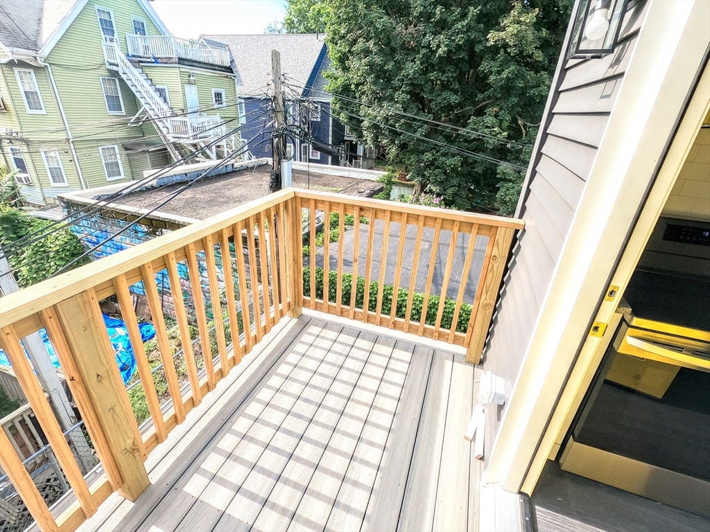 2 Sunnyside Street, Unit 2 Boston, MA 02130 - Photo 39 of 41 a view of balcony with wooden floor and fence