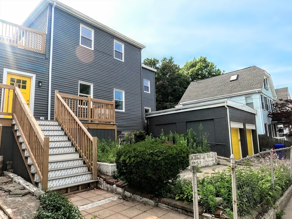 2 Sunnyside Street, Unit 2 Boston, MA 02130 - Photo 41 of 41 a view of a house with wooden stairs and a small yard