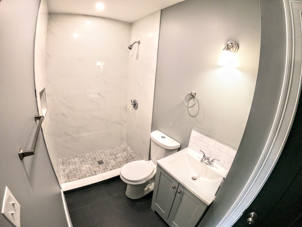 2 Sunnyside Street, Unit 2 Boston, MA 02130 - Photo 9 of 41 a bathroom with a toilet a sink and a shower