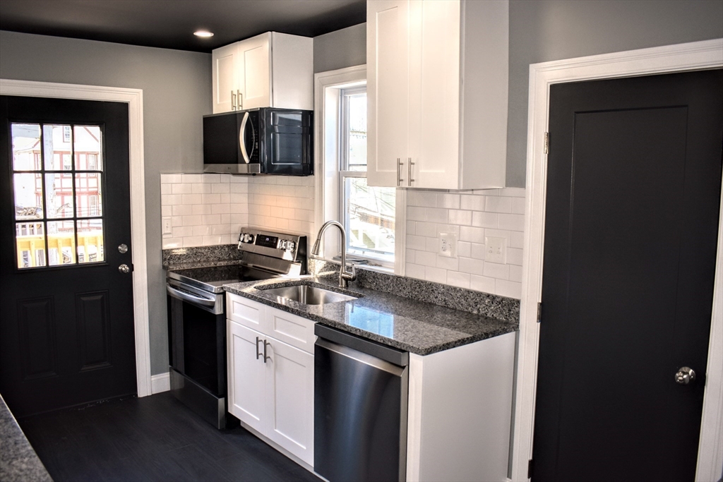 2 Sunnyside Street, Unit 2 Boston, MA 02130 - Photo 10 of 41 a kitchen with stainless steel appliances granite countertop a sink stove and refrigerator