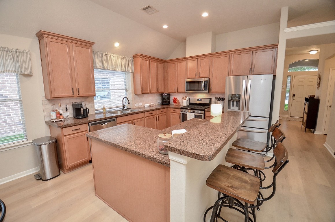 9222 Sorrell Hollow Lane Rosenberg, TX 77469 - Photo 16 of 46 Spacious kitchen with abundant cabinetry, generous counter space, and bar seating—perfect for everyday living and casual dining.
