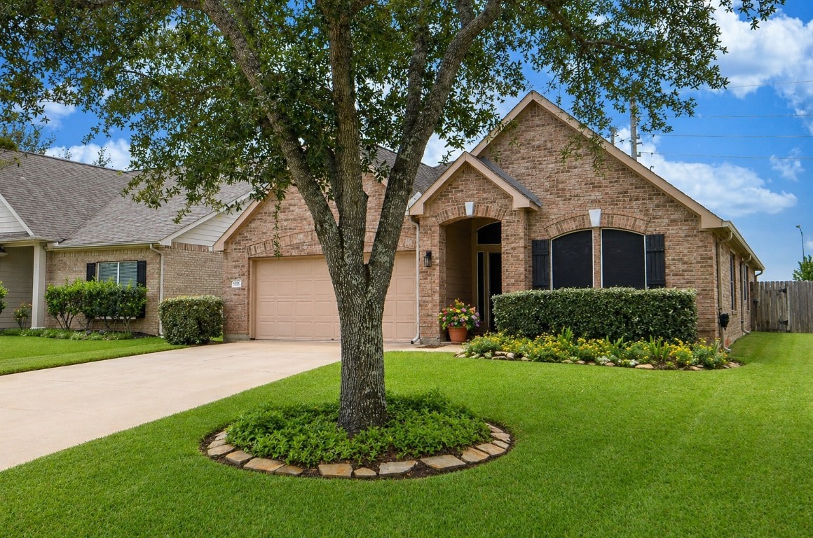 9222 Sorrell Hollow Lane Rosenberg, TX 77469 - Photo 2 of 46 Spacious driveway and attached garage provide ample parking, complemented by a well-kept exterior and landscaping.