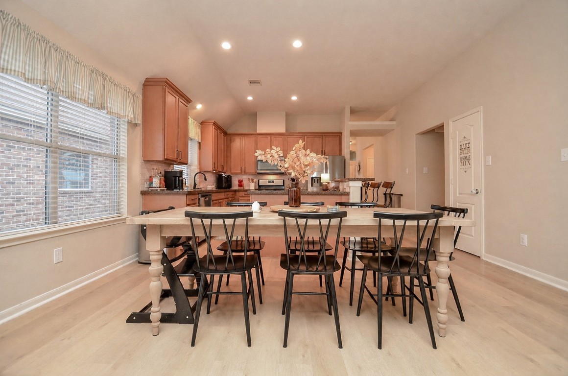 9222 Sorrell Hollow Lane Rosenberg, TX 77469 - Photo 22 of 46 Light-filled dining space with large windows, creating a bright and welcoming atmosphere for gatherings.
