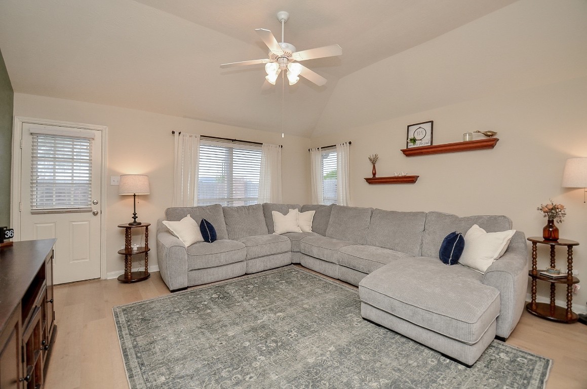 9222 Sorrell Hollow Lane Rosenberg, TX 77469 - Photo 23 of 46 Spacious living room featuring a large sectional, abundant natural light, and a comfortable layout perfect for relaxing or entertaining.