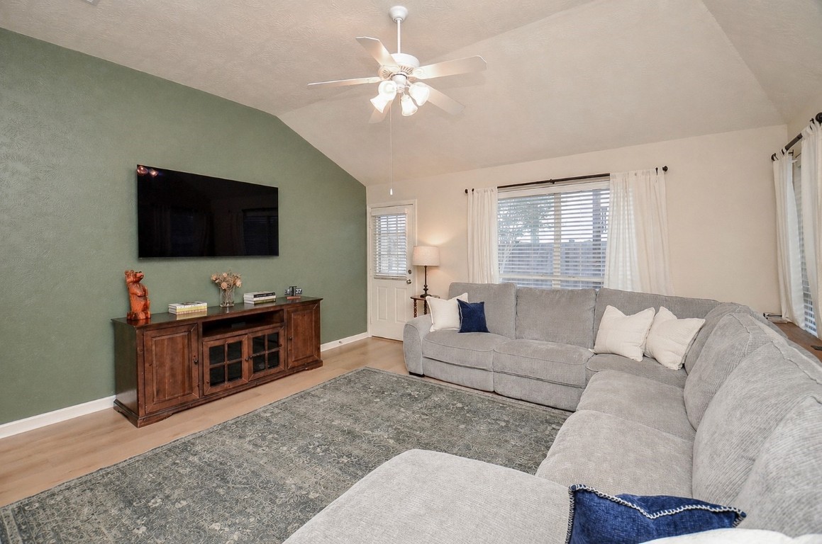 9222 Sorrell Hollow Lane Rosenberg, TX 77469 - Photo 25 of 46 Inviting living area with a striking accent wall, ideal for a media setup and cozy nights at home.