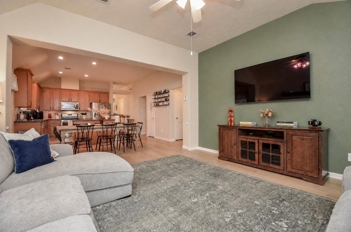 9222 Sorrell Hollow Lane Rosenberg, TX 77469 - Photo 26 of 46 Generous living room opens effortlessly to the kitchen and dining spaces, offering a bright and connected environment designed for modern living.