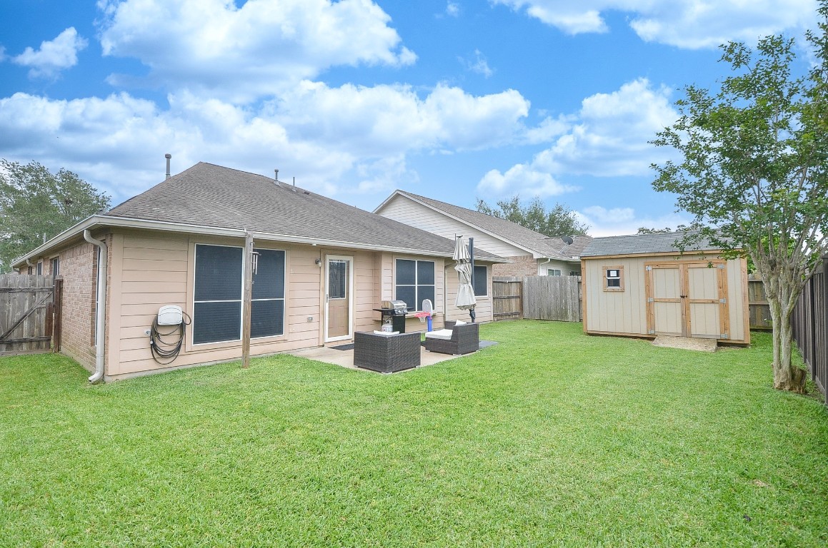 9222 Sorrell Hollow Lane Rosenberg, TX 77469 - Photo 43 of 46 Generous backyard offering plenty of green space, a patio for outdoor enjoyment, and a 10x12 shed (2025).
