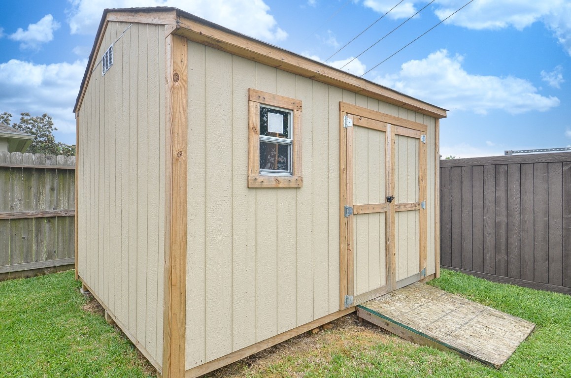9222 Sorrell Hollow Lane Rosenberg, TX 77469 - Photo 46 of 46 Spacious 10x12 storage shed with interior shelving, added in 2025 and included with the property.