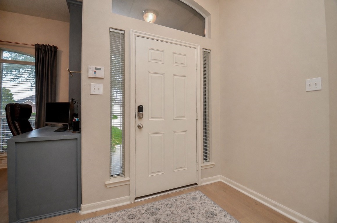 9222 Sorrell Hollow Lane Rosenberg, TX 77469 - Photo 5 of 46 Step inside to an inviting layout with updated flooring and a seamless flow into the main living areas, creating a warm and functional first impression.