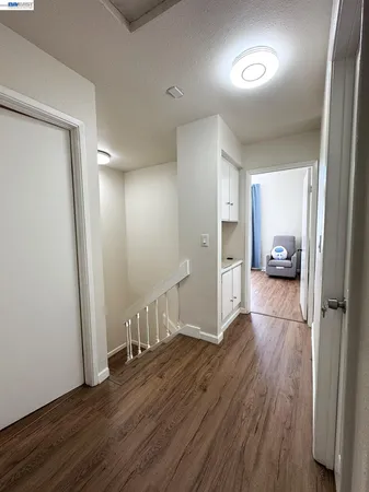 a view of hallway with wooden floor