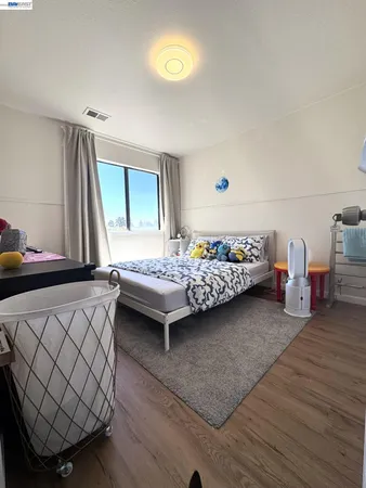 a bedroom with furniture and a window