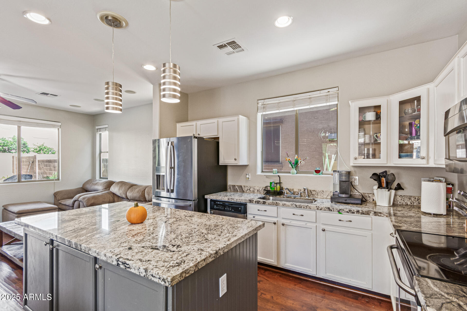 3802 East Chickadee Road Gilbert, AZ 85297 - Photo 11 of 29 a kitchen with granite countertop a sink stove and refrigerator
