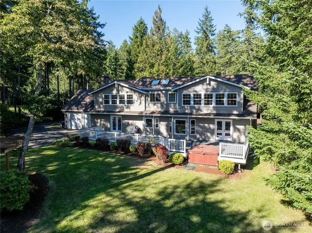 an aerial view of a house with swimming pool and garden