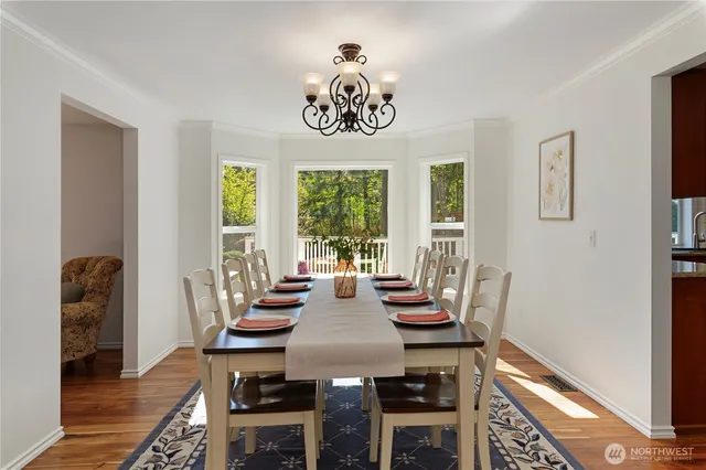 a view of a dining room with furniture window and wooden floor
