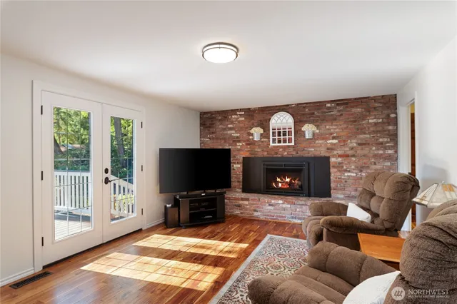 a living room with furniture a fireplace and a flat screen tv