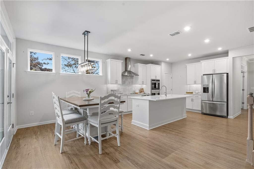 15 Parkside View Cartersville, GA 30121 - Photo 17 of 49 a kitchen with stainless steel appliances kitchen island granite countertop a dining table chairs and granite counter tops