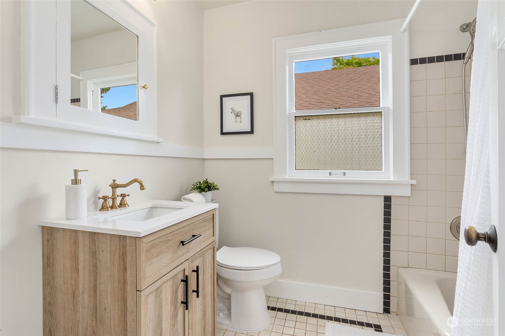 2368 North 52nd Street Seattle, WA 98103 - Photo 16 of 32 a bathroom with a sink vanity mirror and toilet
