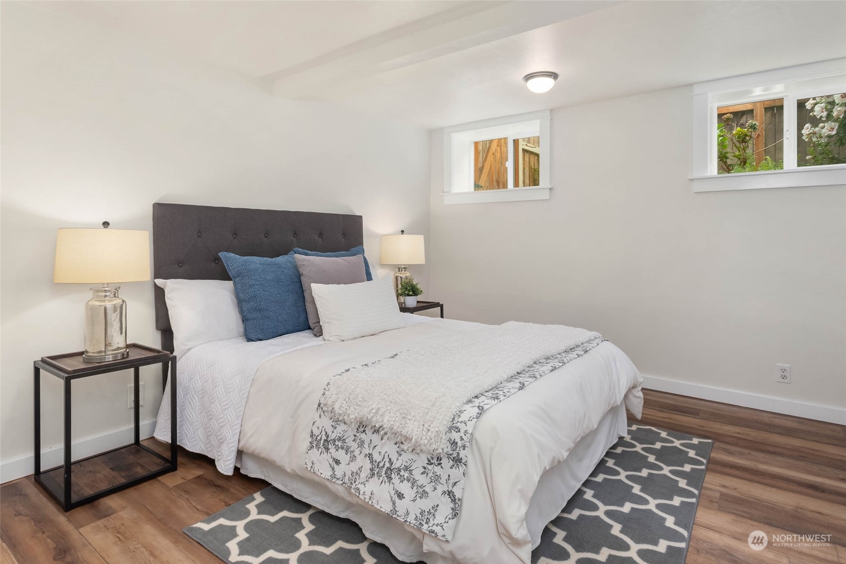 2368 North 52nd Street Seattle, WA 98103 - Photo 24 of 32 a bedroom with a bed and a lamp