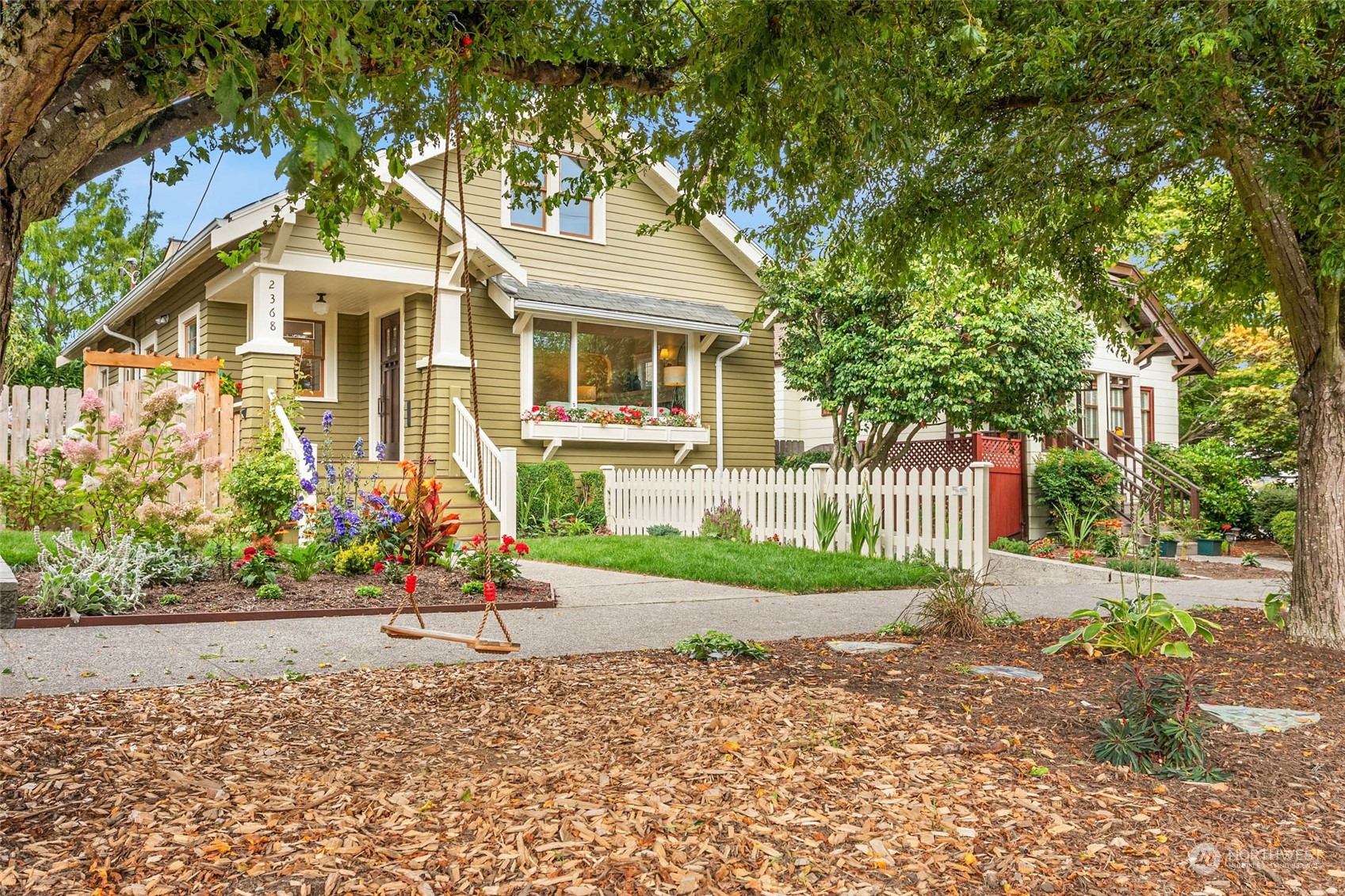 2368 North 52nd Street Seattle, WA 98103 - Photo 6 of 32 a view of a white house with large windows and a small yard