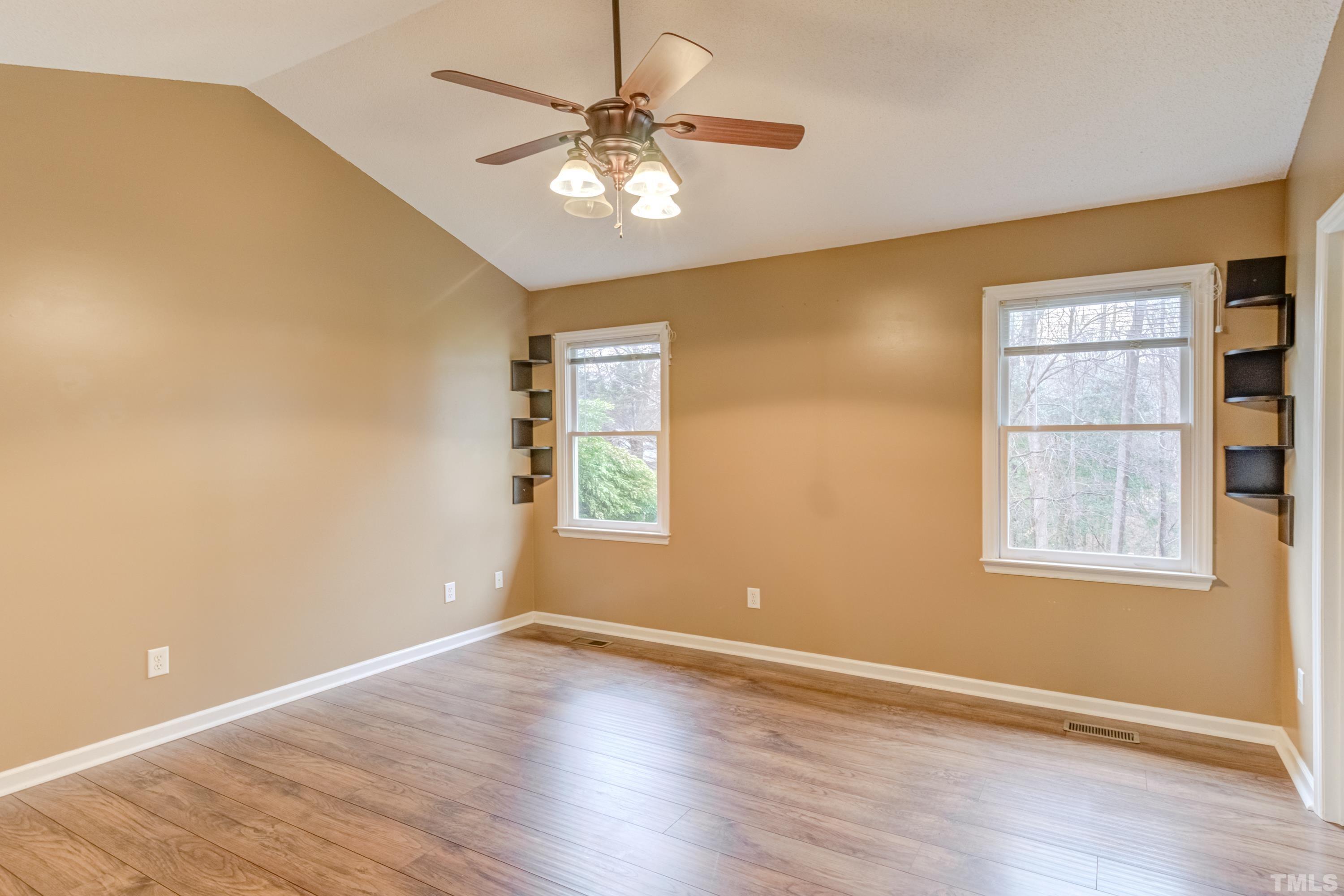 605 Jordan Ridge Lane Raleigh, NC 27603 - Photo 17 of 36 a view of an empty room with a window and wooden floor