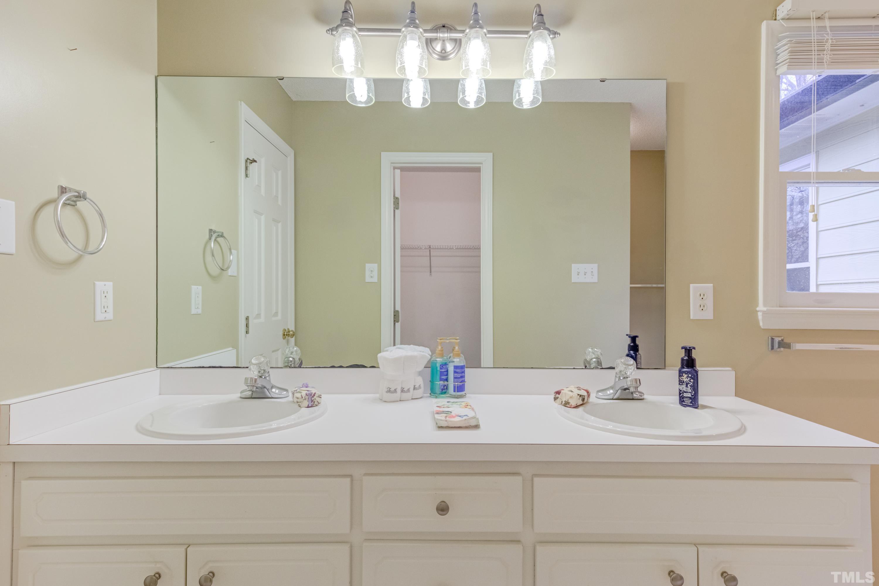 605 Jordan Ridge Lane Raleigh, NC 27603 - Photo 20 of 36 a bathroom with a sink and a mirror