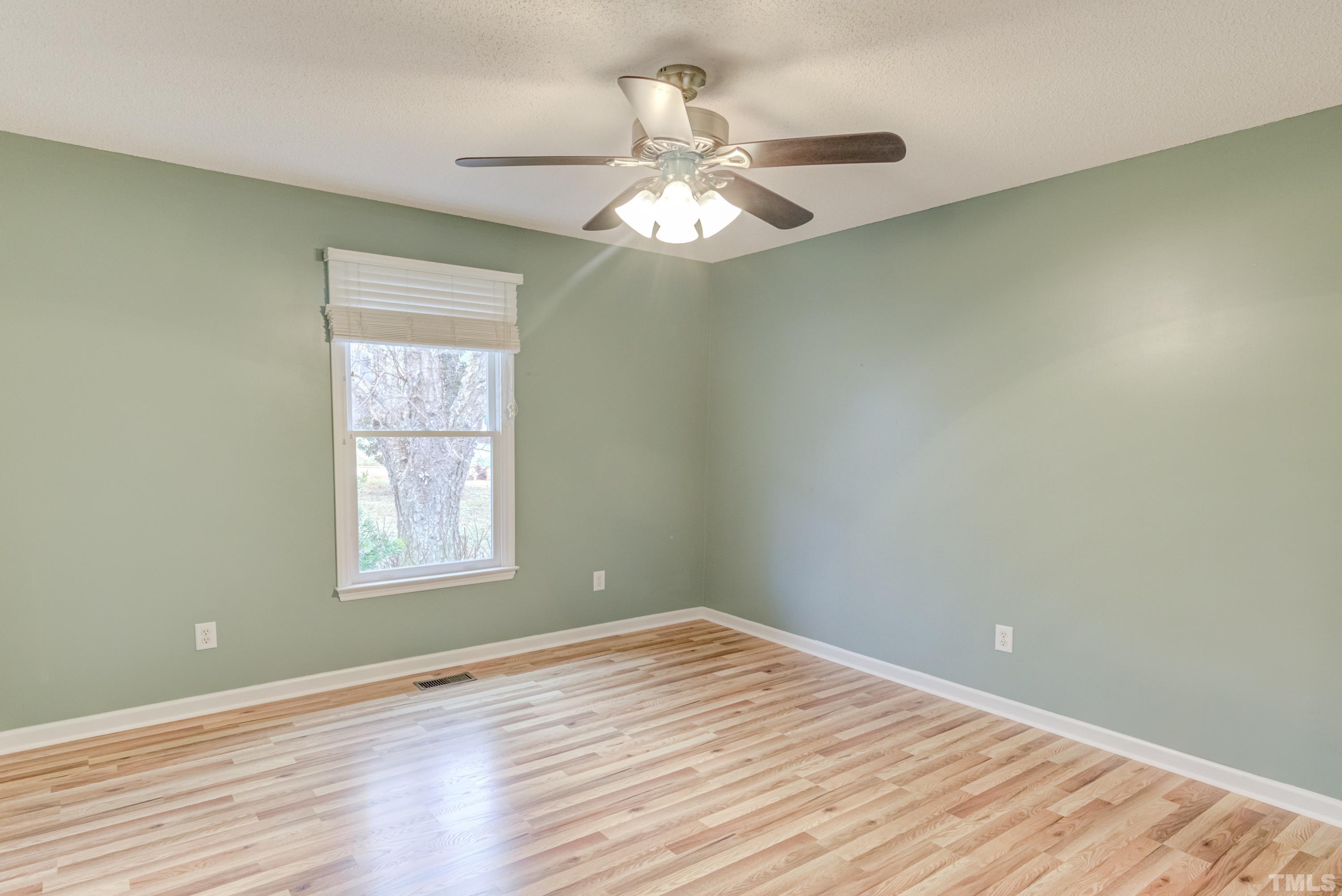 605 Jordan Ridge Lane Raleigh, NC 27603 - Photo 23 of 36 an empty room with wooden floor fan and windows