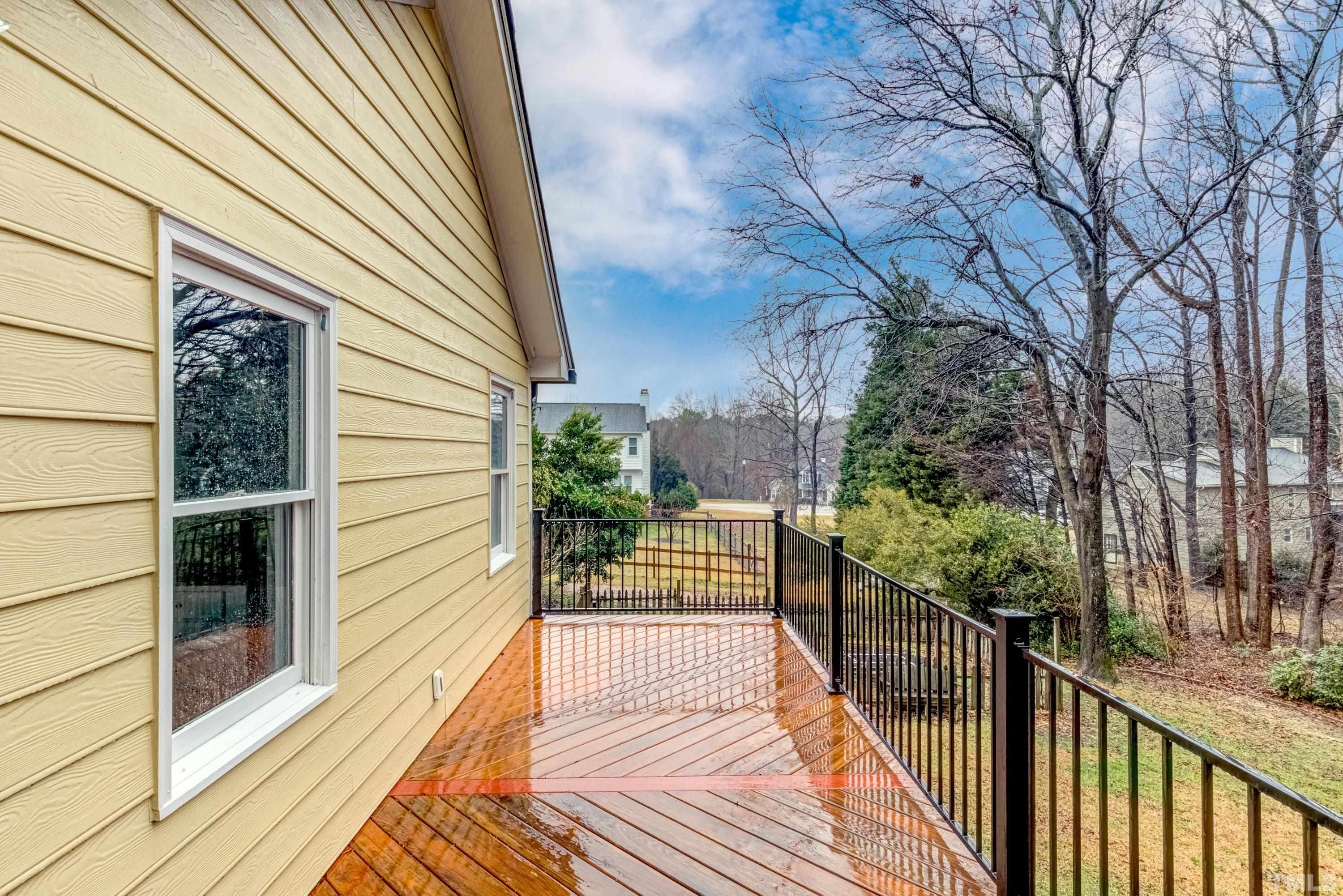 605 Jordan Ridge Lane Raleigh, NC 27603 - Photo 28 of 36 a view of a balcony with wooden floor and fence