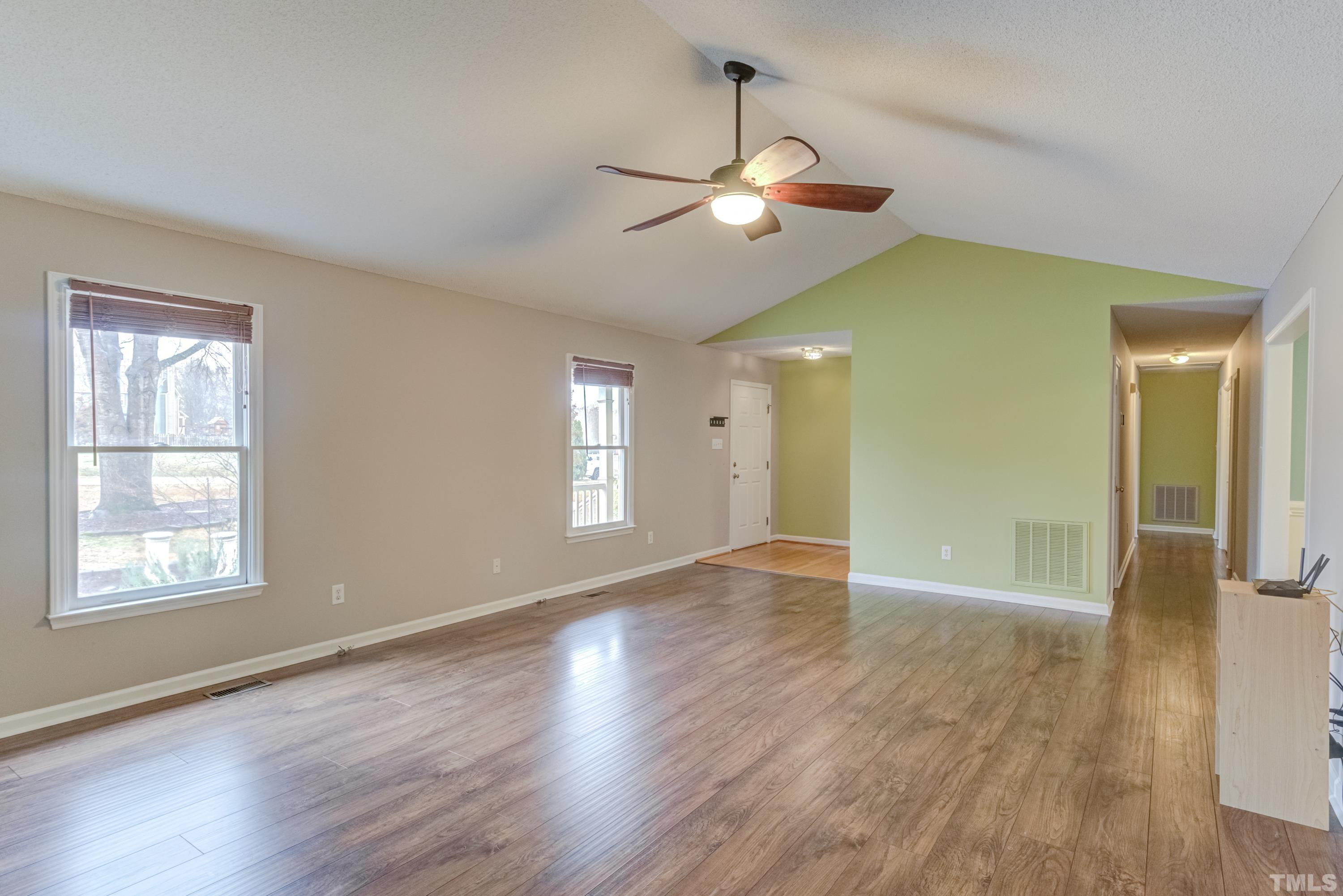 605 Jordan Ridge Lane Raleigh, NC 27603 - Photo 5 of 36 a view of an empty room with window and wooden floor