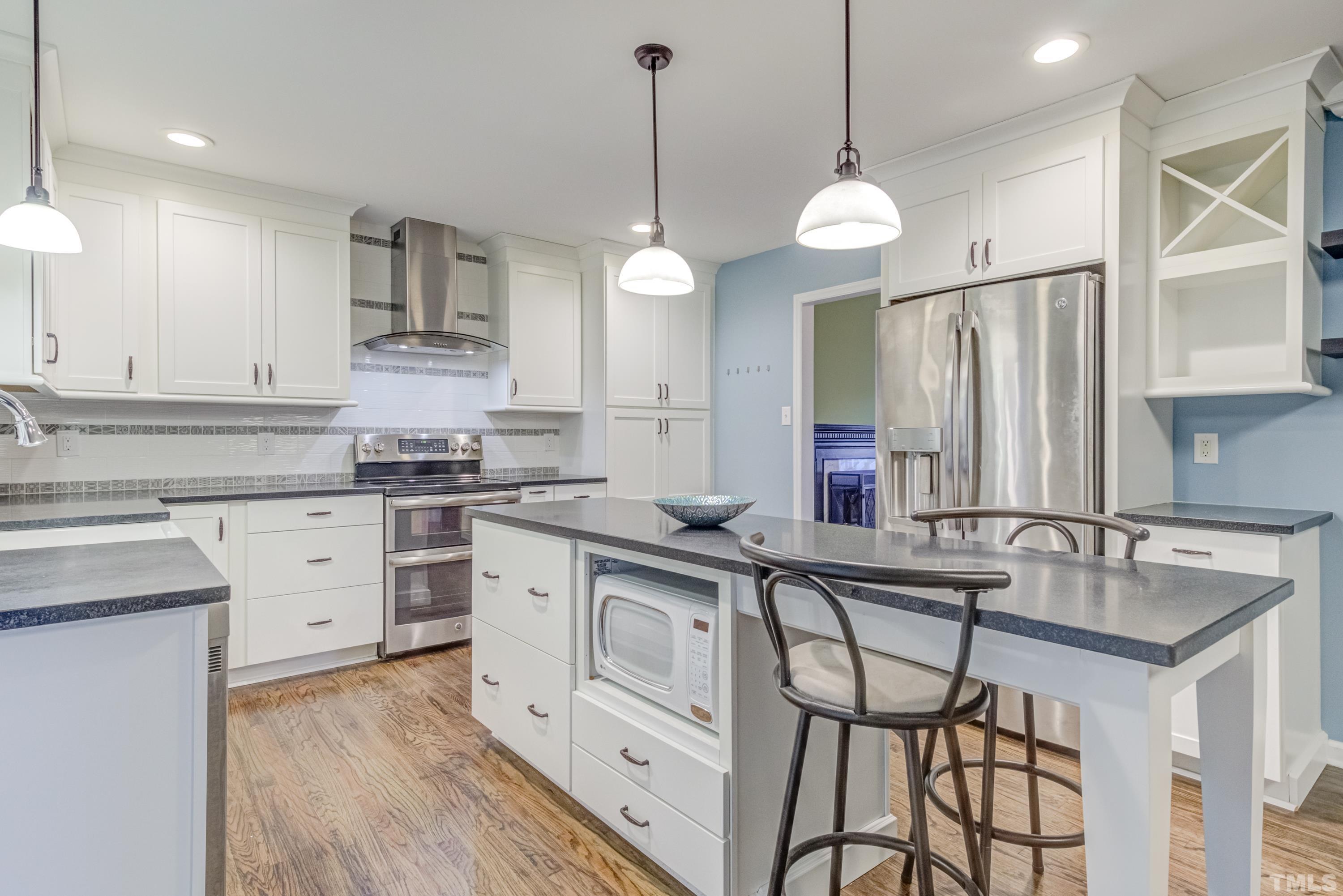 605 Jordan Ridge Lane Raleigh, NC 27603 - Photo 9 of 36 a kitchen with white cabinets and sink
