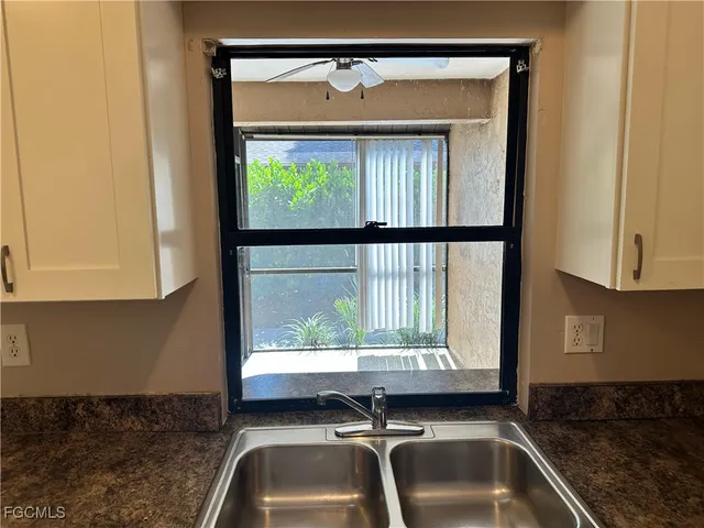 a kitchen with sink cabinets and window