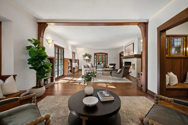 a living room with furniture and potted plants