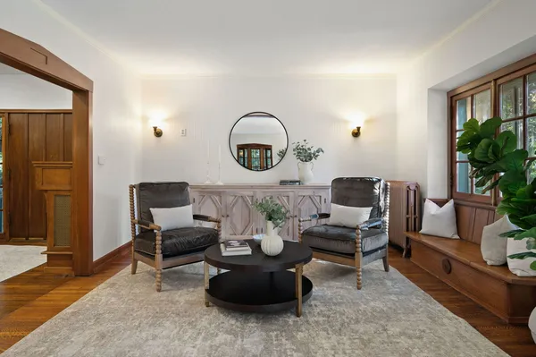 a living room with furniture and potted plants
