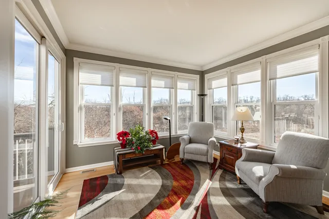a living room with furniture and a floor to ceiling window