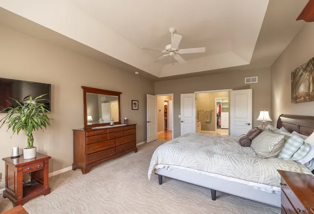 a bedroom with a bed and a chandelier