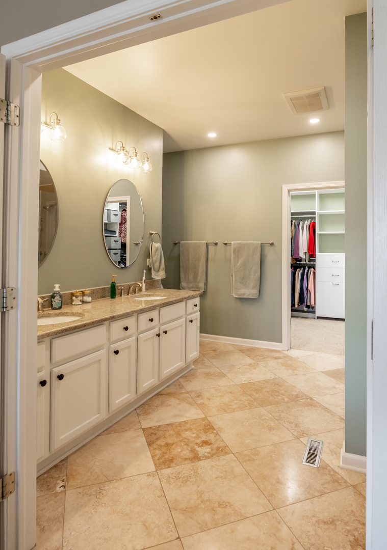 2737 Winton Court West Dundee, IL 60118 - Photo 27 of 52 a spacious bathroom with a mirror sink and vanity
