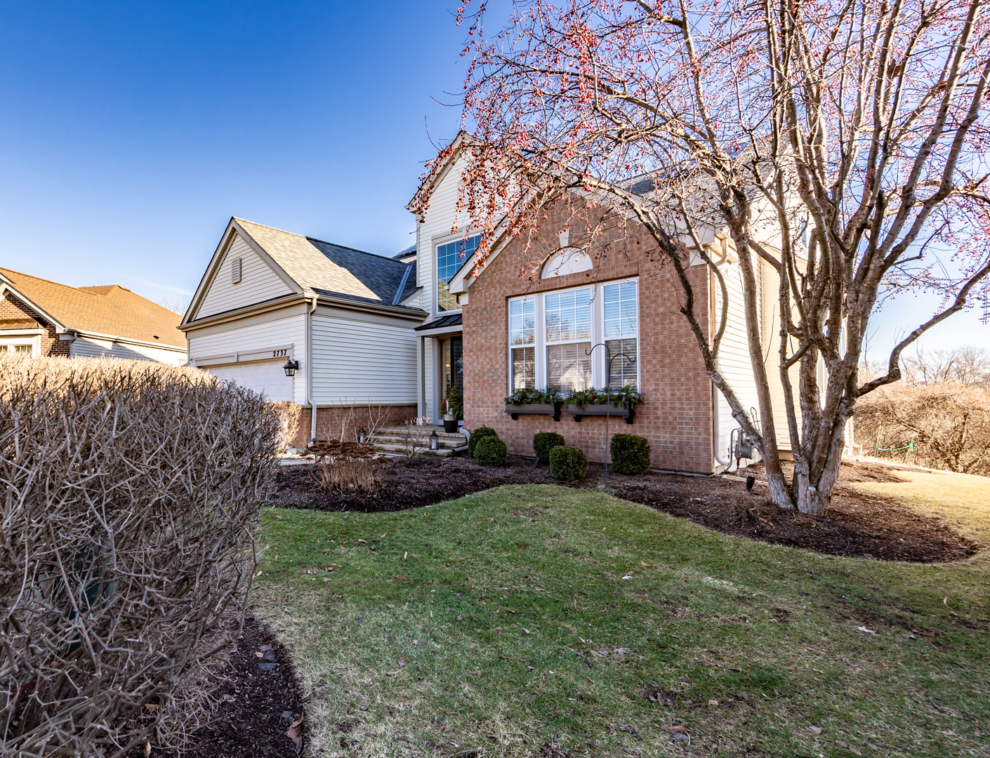 2737 Winton Court West Dundee, IL 60118 - Photo 3 of 52 a front view of a house with a garden and trees