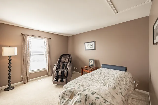 a bedroom with a bed and a large mirror