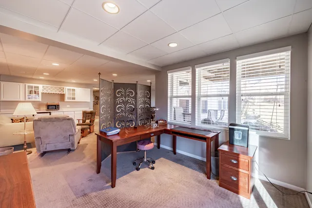 a living room with furniture a dining table and a large window
