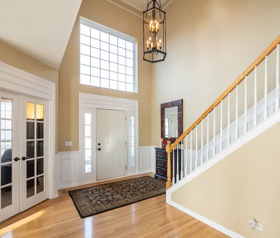a view of a hallway with wooden floor and staircase