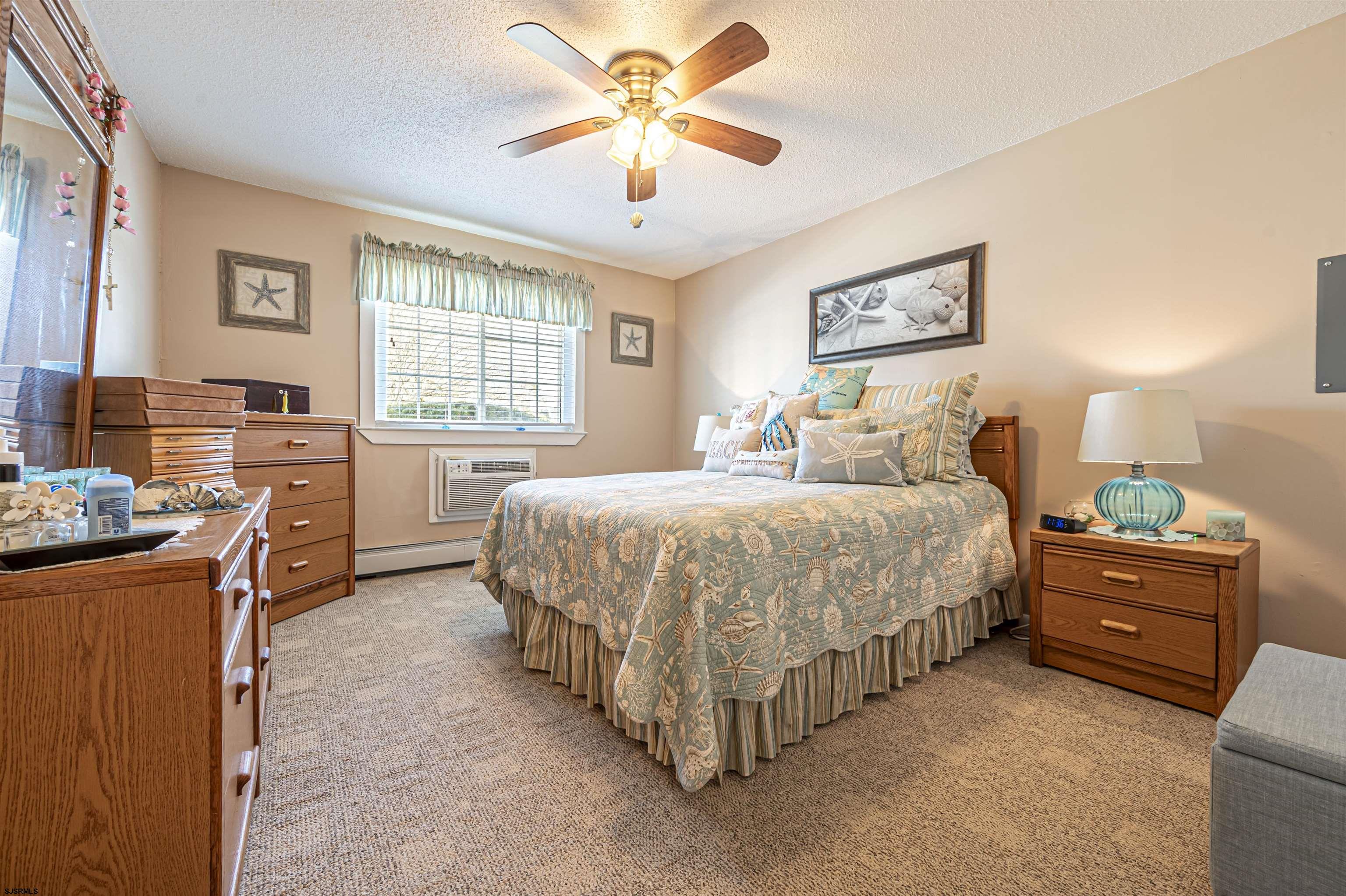 4901 Harbor Beach Boulevard, Unit Q3 Brigantine, NJ 08203 - Photo 11 of 19 a spacious bedroom with a bed and a chandelier